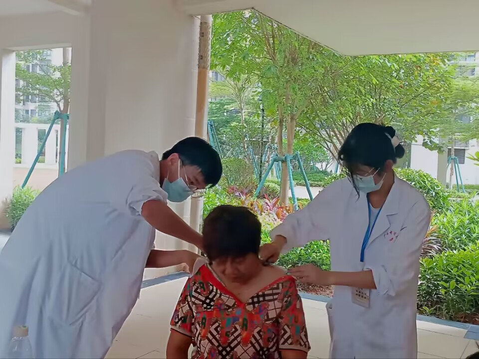 同学们在给社区居民进行刮痧